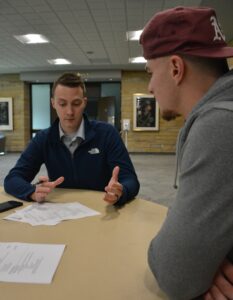 Student having resume reviewed by local employer