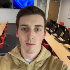 Callahan stands in the Business Intelligence Lab in Aquinas Hall