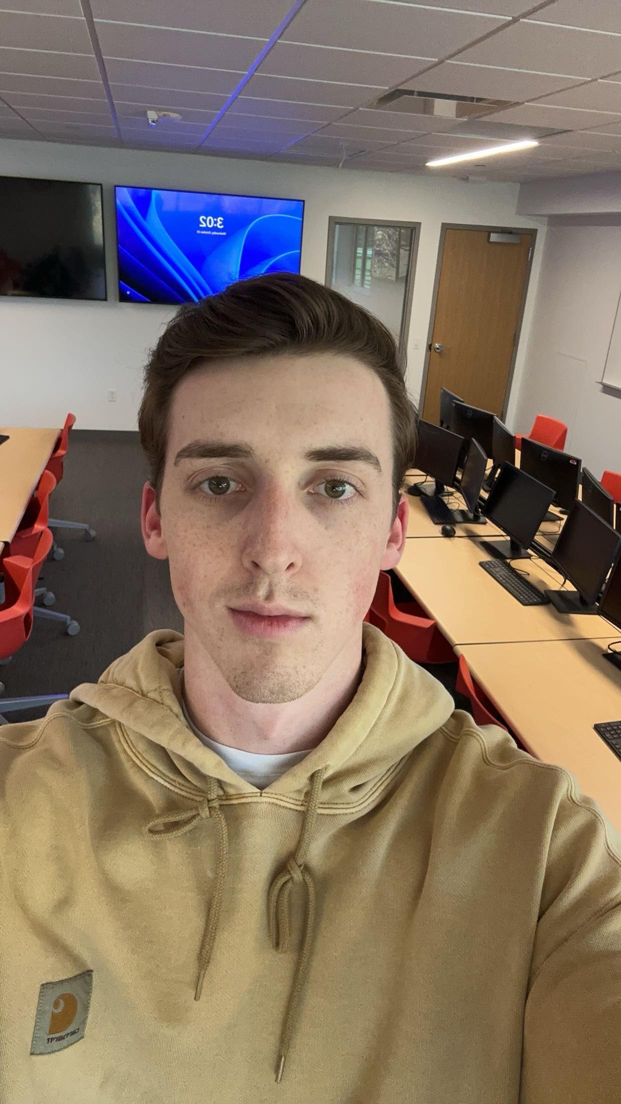 Callahan stands in the Business Intelligence Lab in Aquinas Hall