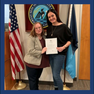 Dr. Mallory Knipe and colleague Emily Miller pose with Aidmiration’s official certificate of incorporation.