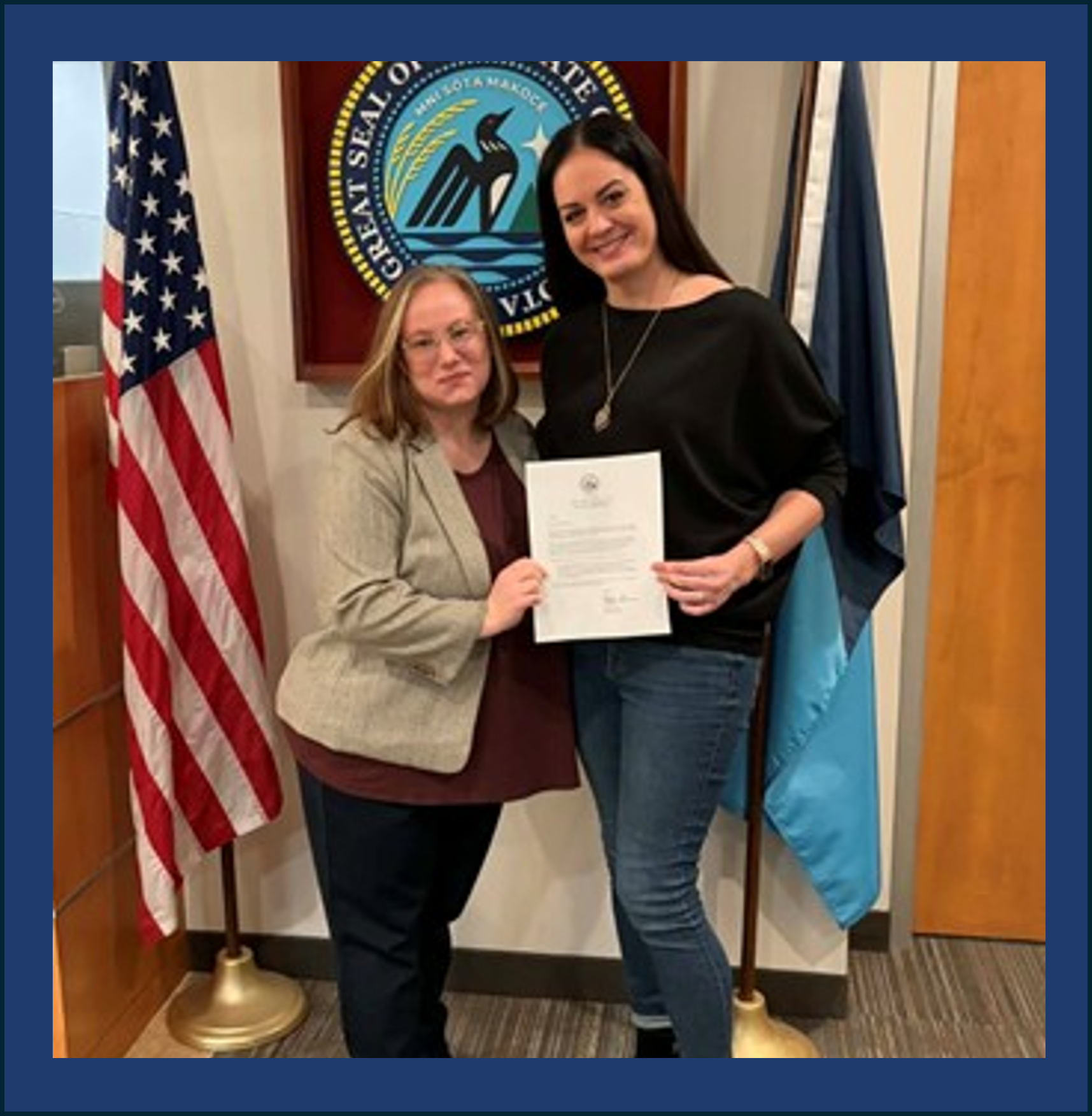 Dr. Mallory Knipe and colleague Emily Miller pose with Aidmiration’s official certificate of incorporation.