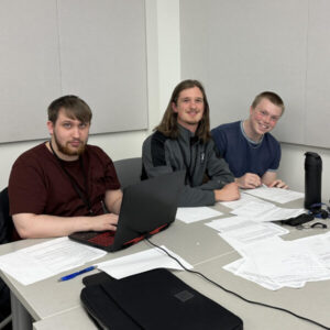Lucas Heindel, Luke Rickert and Joseph Hakanson working on programs